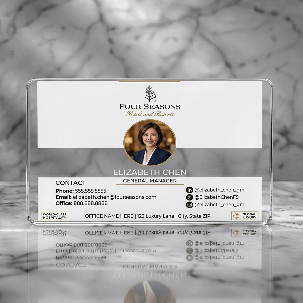 Clear plastic business card featuring elegant white and gold design with serif and sans-serif fonts, professional photo, and social media icons