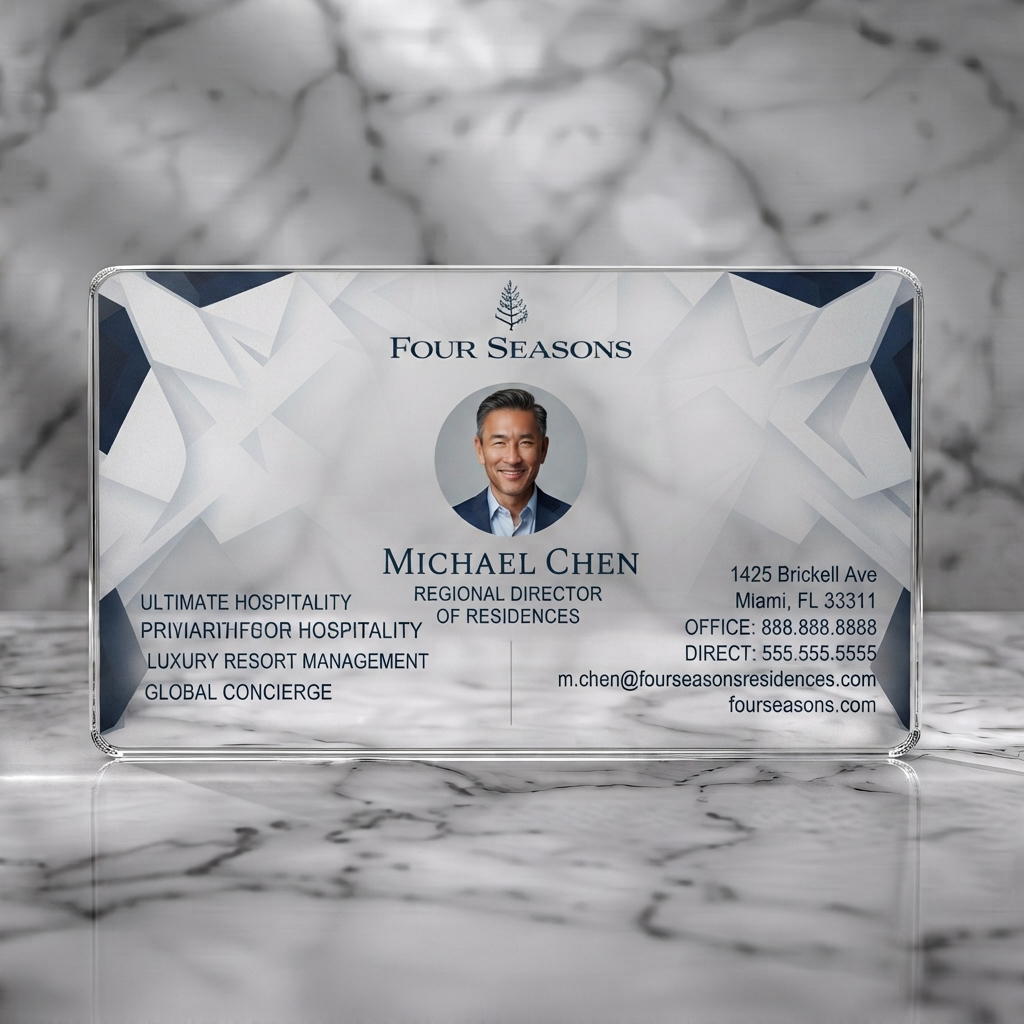 Clear plastic business card featuring modern geometric navy/white pattern, elegant fonts, luxury brand logo, professional headshot