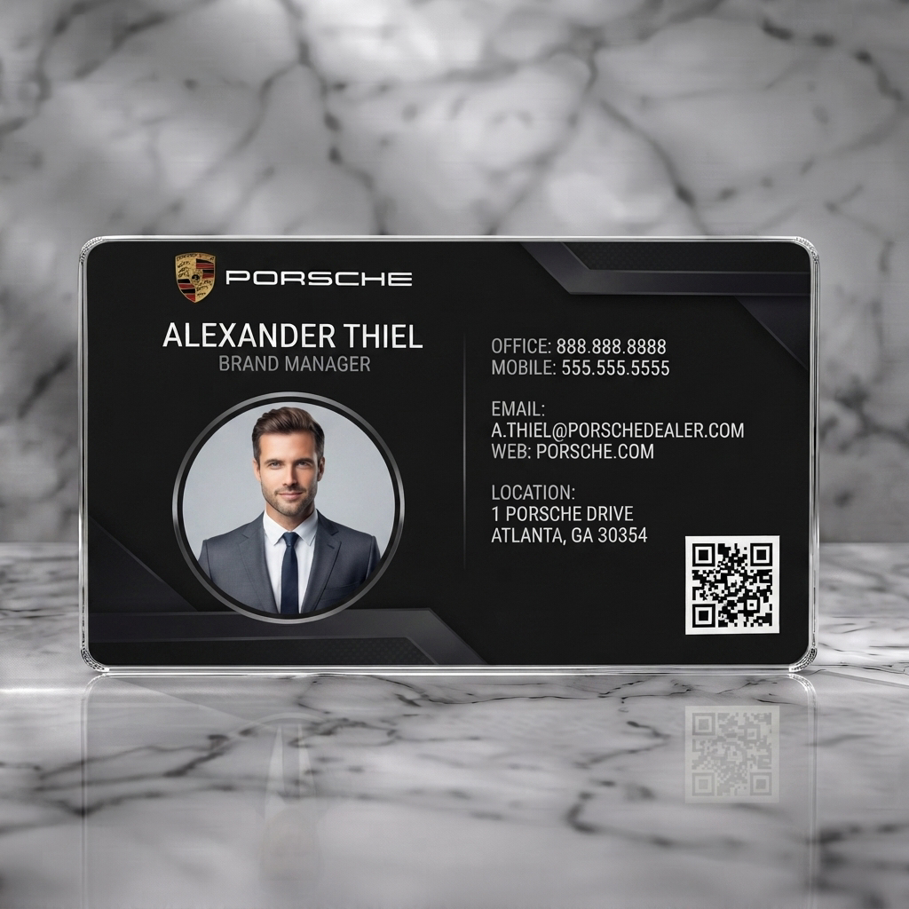 Clear plastic business card featuring a sleek black and silver design, sans-serif typography, Porsche logo, professional headshot, and QR code