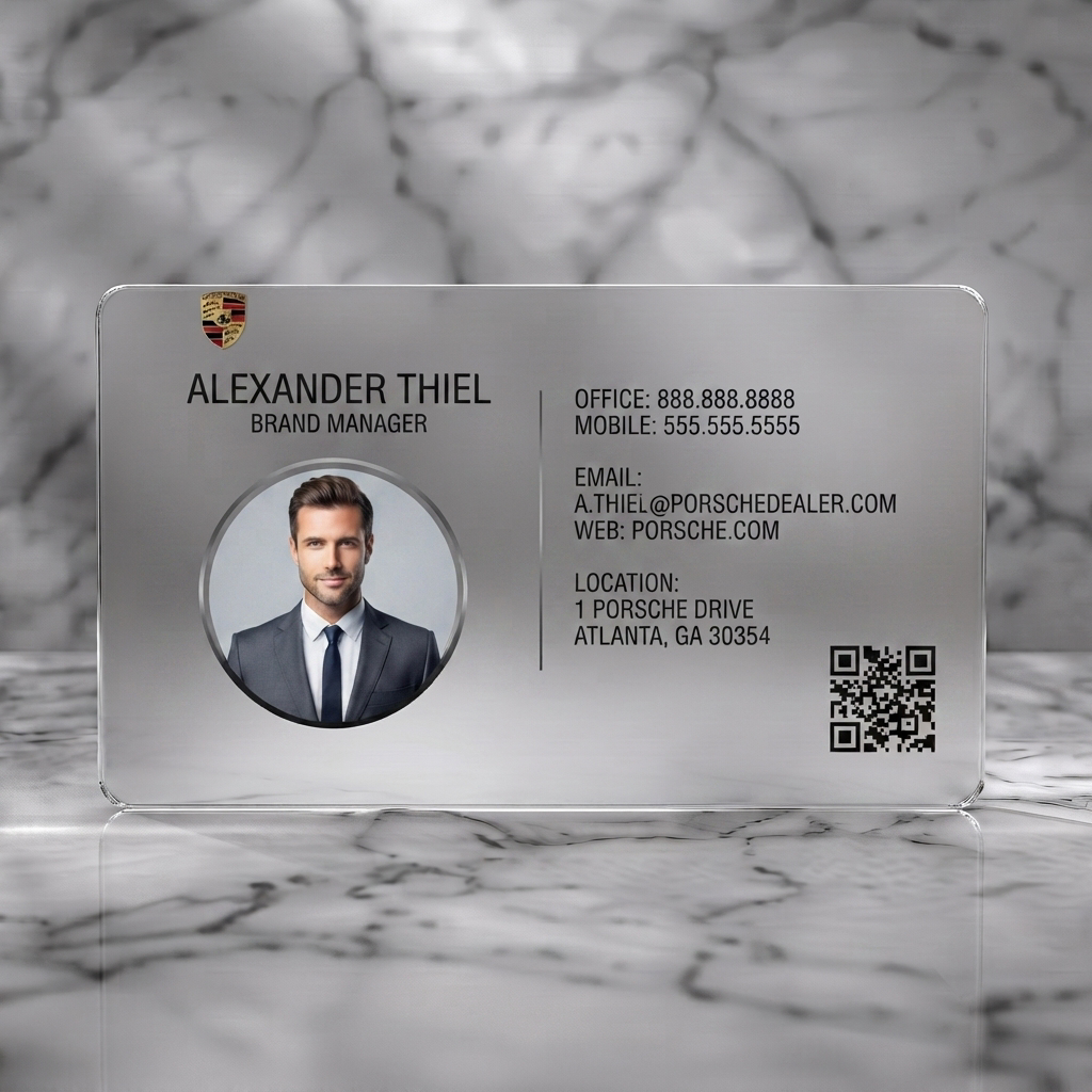 Frosted translucent plastic business card featuring a sleek black and silver design, sans-serif typography, Porsche logo, professional headshot, and QR code