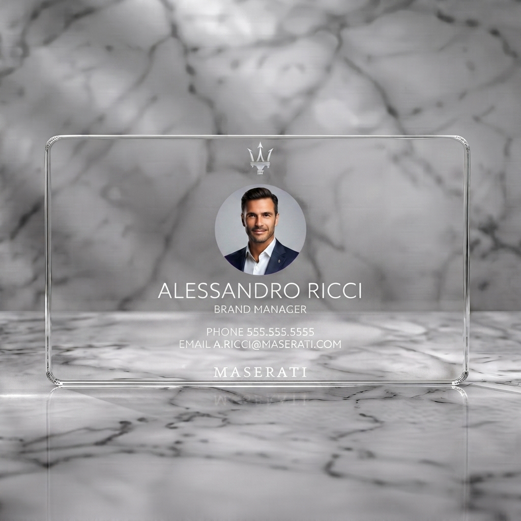 Clear plastic business card featuring a modern navy blue design with crisp white typography, Maserati trident, and a circular headshot