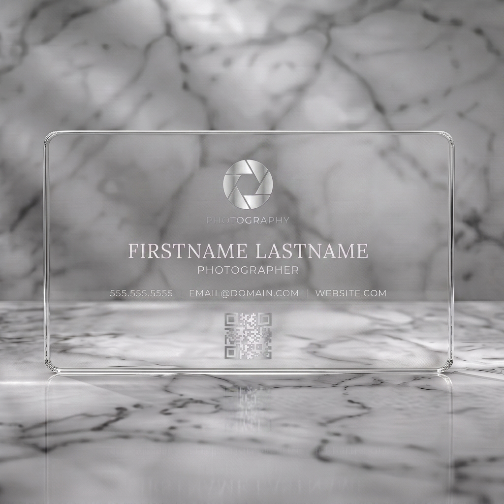 Clear plastic business card featuring clean, modern style with a silver aperture icon, white typography, and QR code