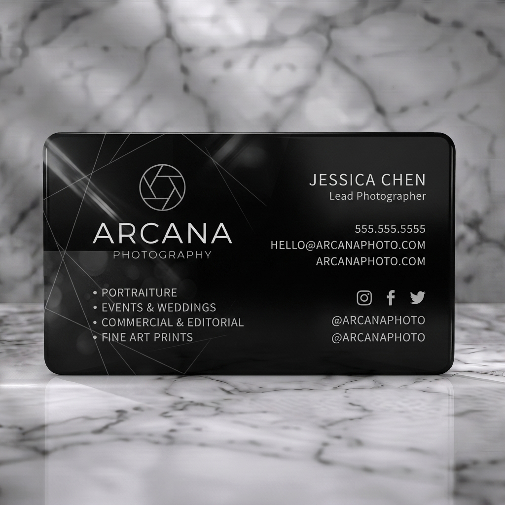 Solid white PVC business card featuring a minimalist black and white design, camera aperture logo, modern sans-serif fonts, and social icons