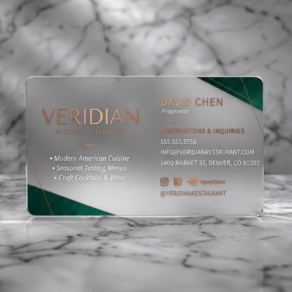 Frosted translucent plastic business card featuring luxurious dark geometric design with copper text, emerald accents, and social media icons