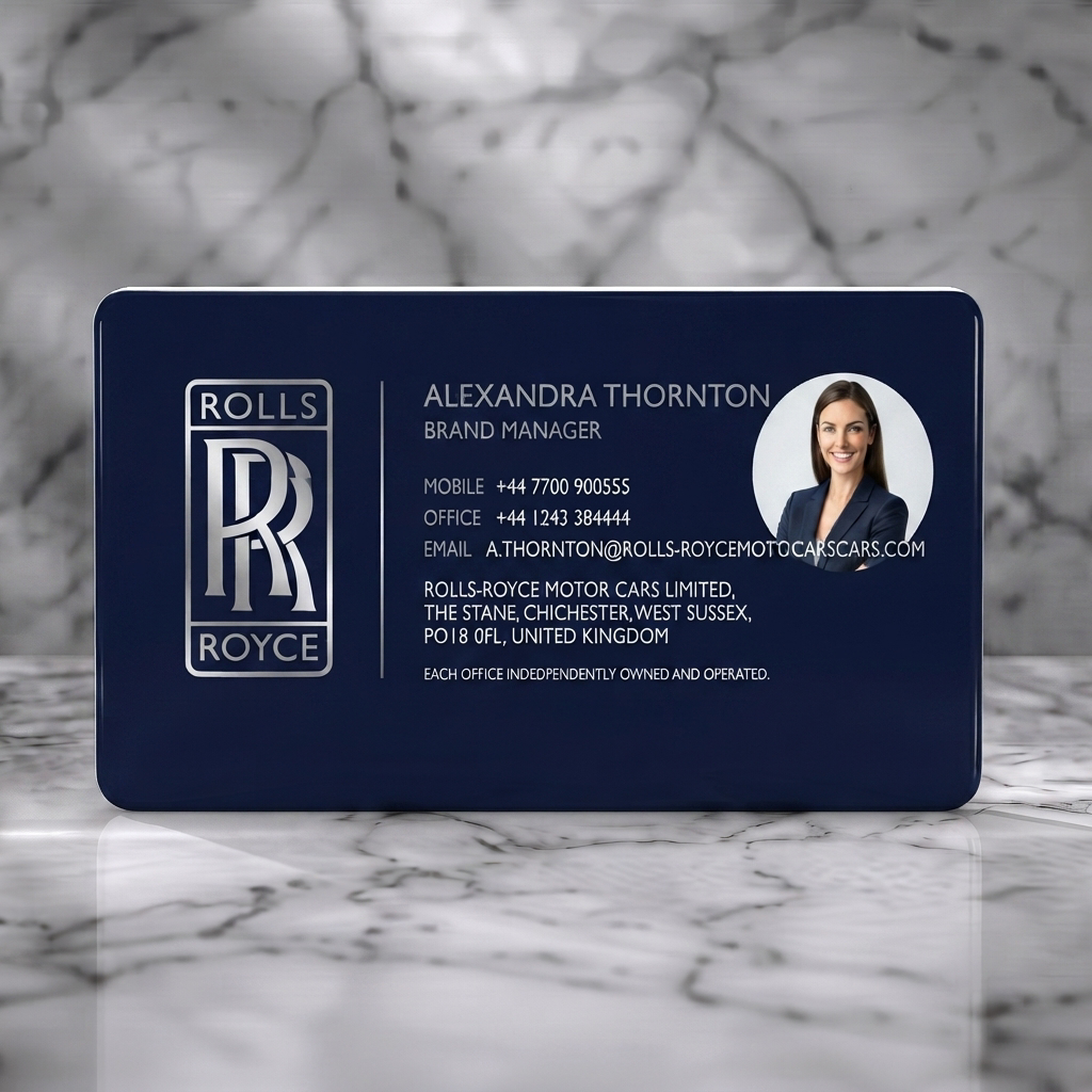 Solid white PVC business card featuring elegant, minimalist design; navy and silver branding; clean sans-serif typography; Rolls-Royce logo and photo