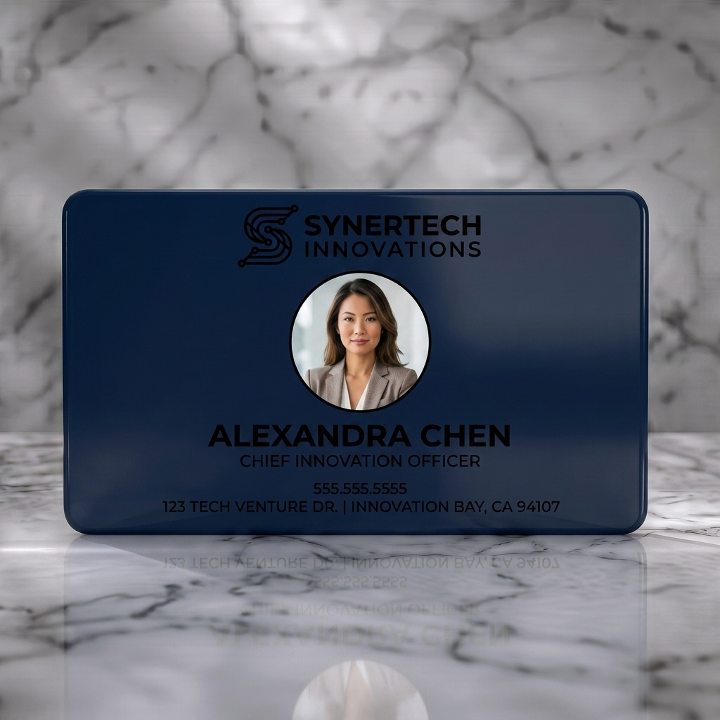 Solid white PVC business card featuring dark indigo tech-circuit logo, modern sans-serif typography, and a professional circular headshot
