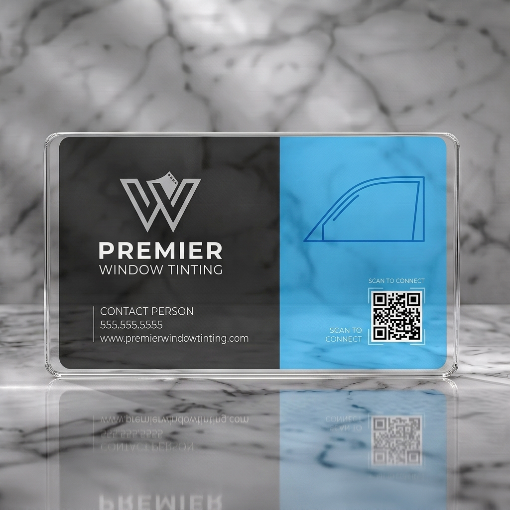 Clear plastic business card featuring modern two-tone blue and grey design, 'W' film-strip logo, car window graphic, QR code