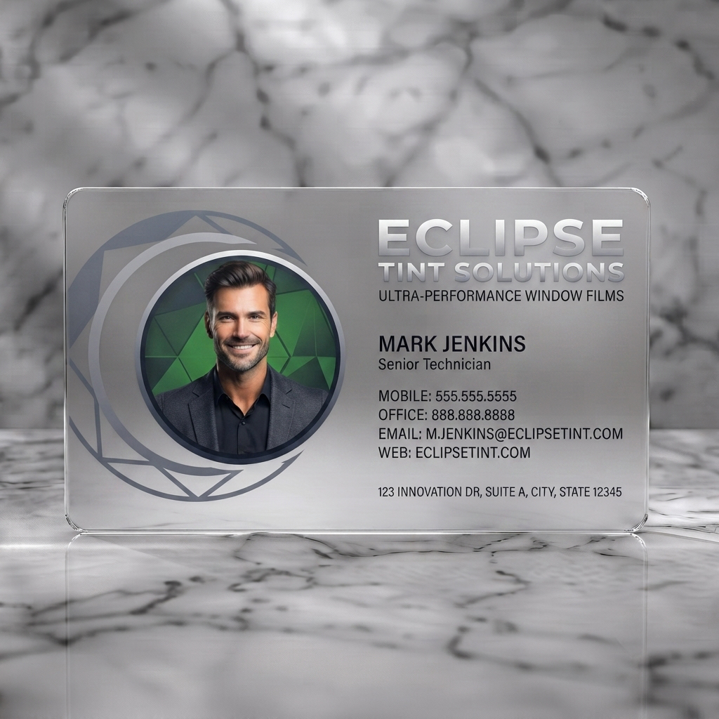 Frosted translucent plastic business card featuring dark, modern card with a circular lens graphic, silver typography, and a professional headshot