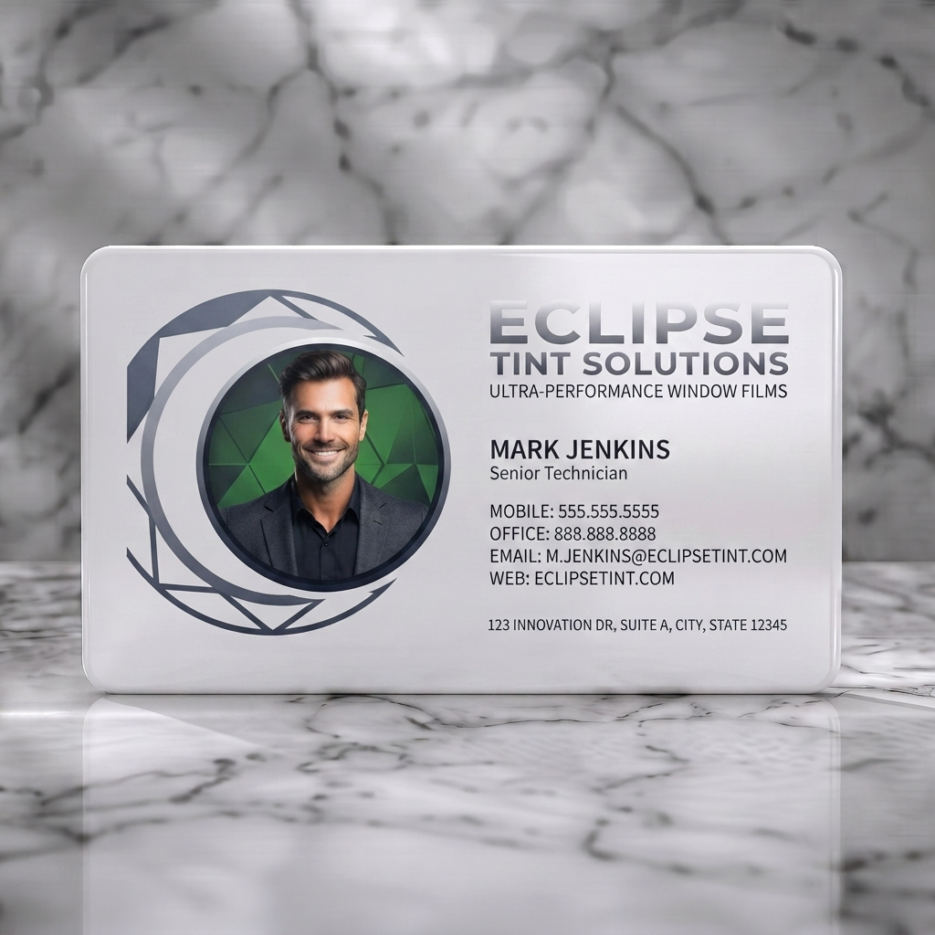 Solid white PVC business card featuring dark, modern card with a circular lens graphic, silver typography, and a professional headshot