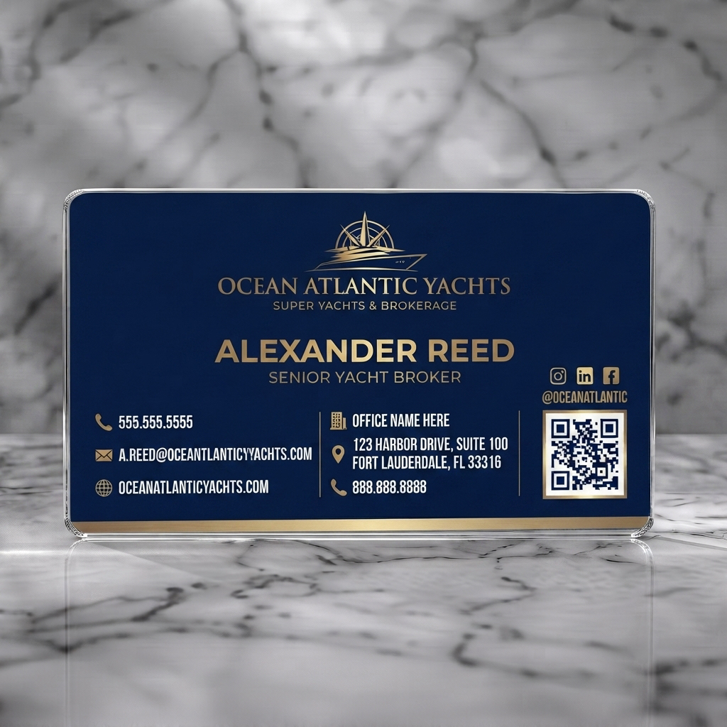 Clear plastic business card featuring elegant navy and gold design, yacht logo, professional typography, and essential contact icons